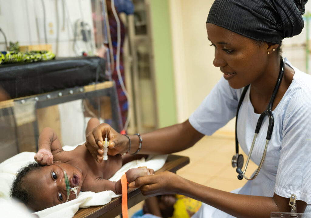 African nurse with child