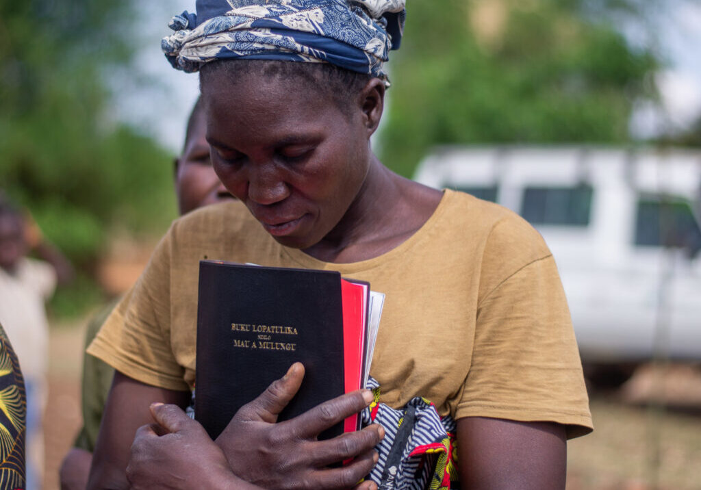 Woman praying with Bible at Nason